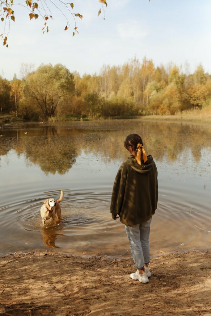  girl-wtching-her-dog-in-the-pond